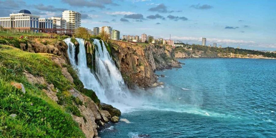 Antalya: Guided City Tour with Waterfalls Tickets and Lunch - Water crashing into the Mediterranean at Düden