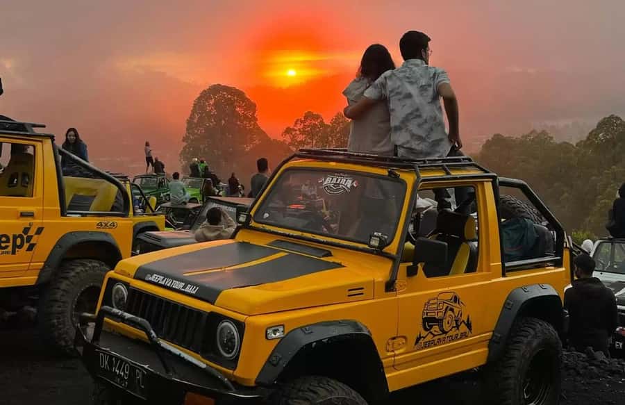 Bali: Mt Batur Jeep Sunrise & Taman Sari Waterfall Tour - Riding through black lava country